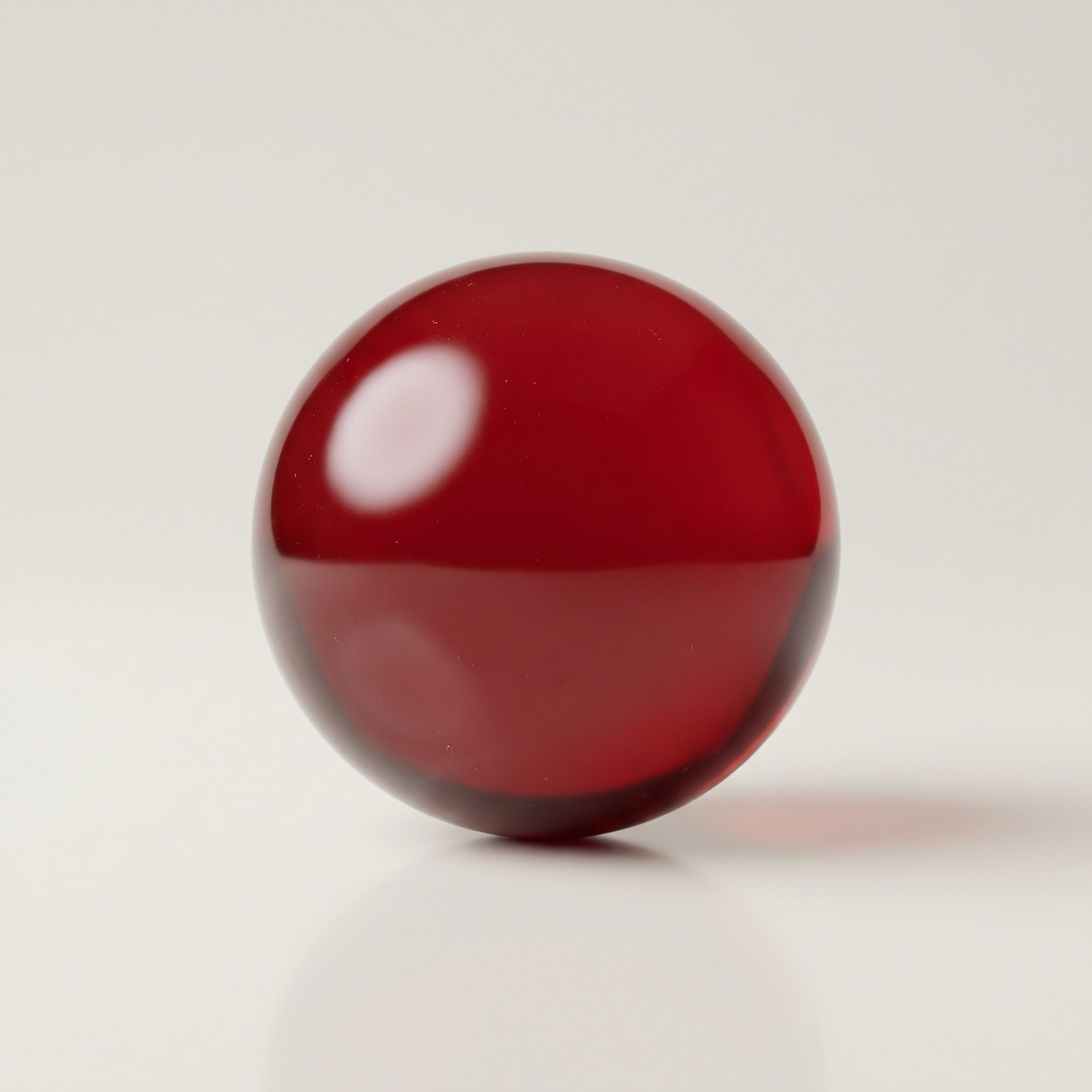A glossy red lacquer sphere